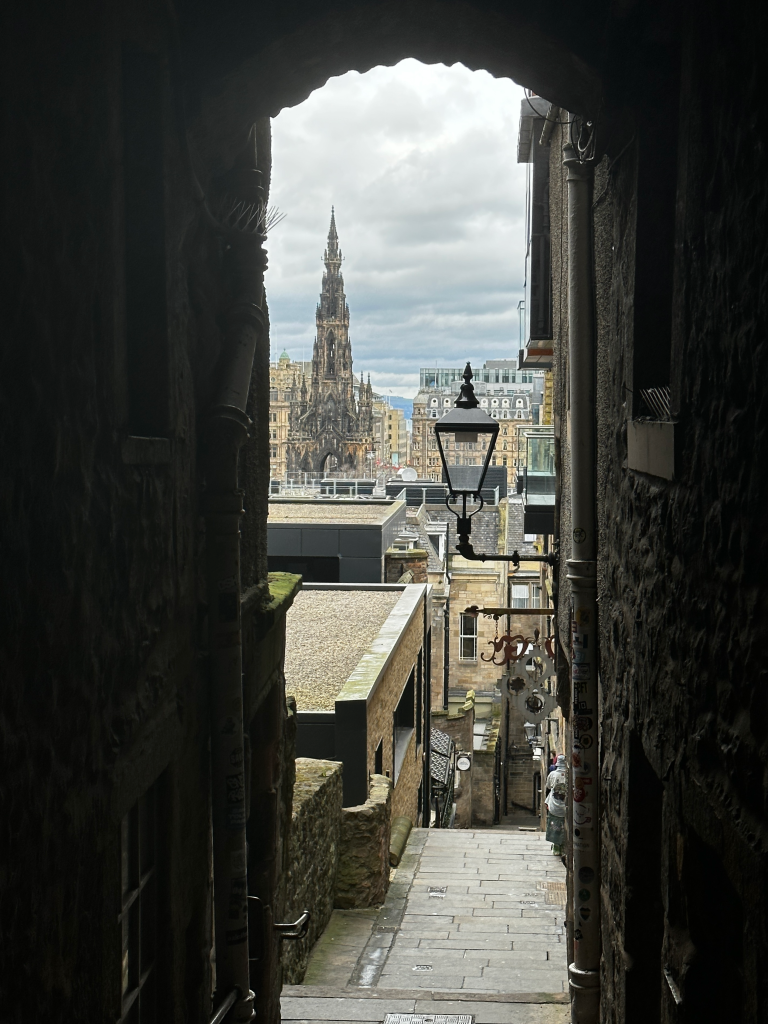 Advocate's Close is a charming and historic alleyway located in the heart of Edinburgh's Old Town, offering a picturesque view of Scott's Monument in the distance.
