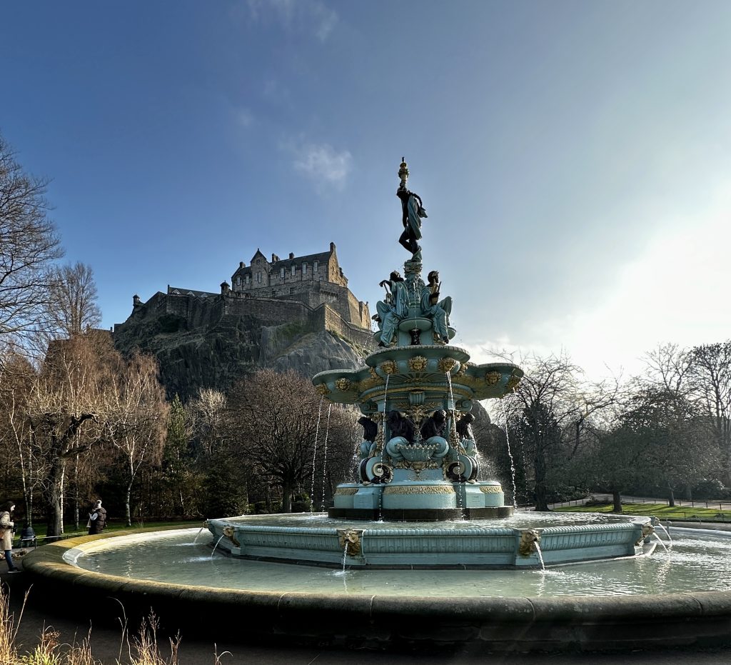 The stunning Ross Fountain in Princess Street Gardens, with the majestic Edinburgh Castle towering in the background, is one of the things to do with kids in Edinburgh. The fountain features several tiers and sculptures that add to its grandeur."