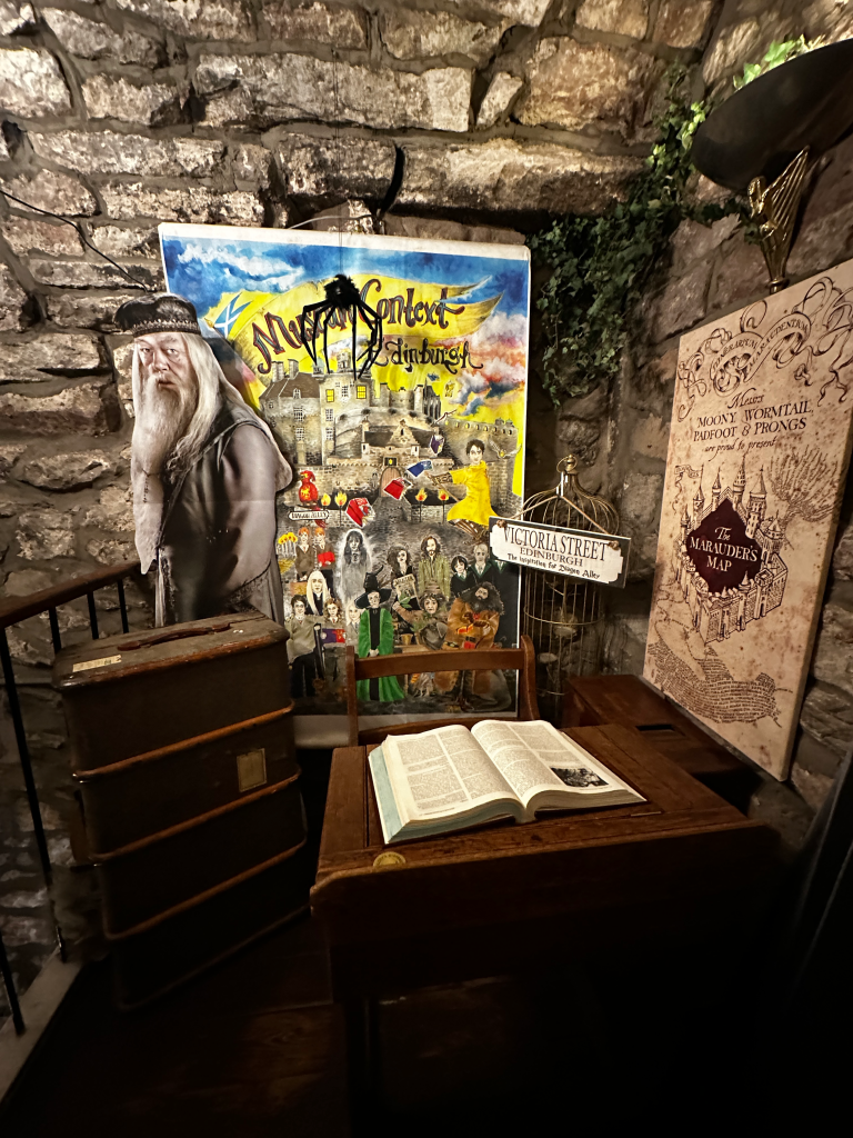 Capture the magic on the 3rd floor of Museum Context, where a charming corner awaits for delightful photo opportunities. A desk adorned with a book, with Dumbledore and the iconic Marauder's Map and other Harry Potter-related items in the background.
