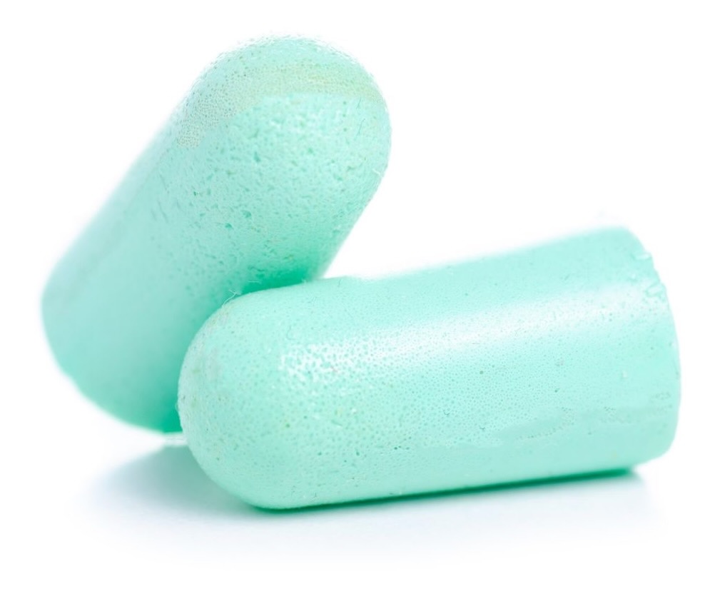 Close-up of a pair of soft mint green foam earplugs against a white background. A lightweight and useful travel stocking stuffer to block out noise on planes, in hotels, or anywhere quiet is needed.