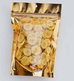 Shiny gold resealable pouch filled with thin, round banana chips, viewed from the front.