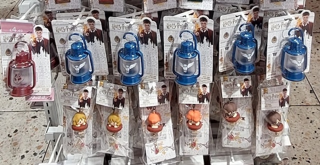 Display of Harry Potter-themed mini lantern keychains and chibi-style character clips featuring Ron, Hermione, and Harry. These fun and compact items make playful Harry Potter stocking stuffers for younger fans or collectors.