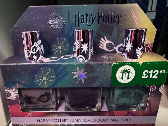 A boxed set of three nail polishes themed after Luna Lovegood, featuring whimsical graphics like her Spectrespecs and priced at £12.50.
