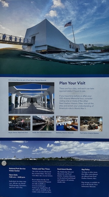 Visitor information board displays a large photograph of the USS Arizona Memorial along with maps, site hours, transportation details, and photos of the Pacific Fleet Submarine Museum, Battleship Missouri Memorial, and Pearl Harbor Aviation Museum. The sign helps visitors plan their itinerary and understand the available attractions.